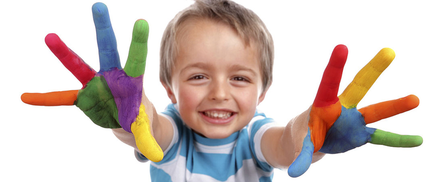 Happy child finger painting at georgie porgies Denton day nursery